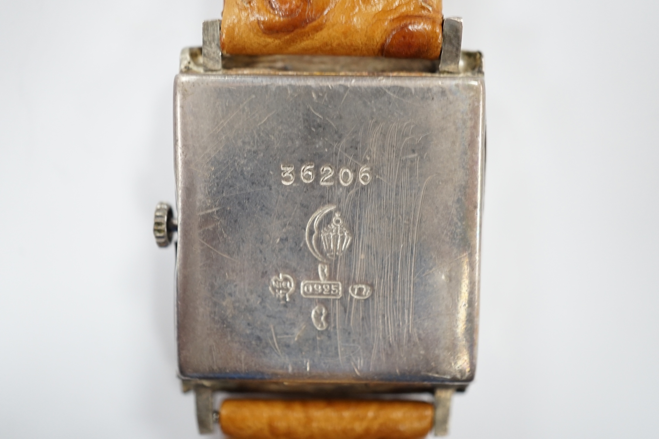 A German sterling manual wind dress wrist watch, retailed by Tiffany & Co, with baton and quarterly Arabic numerals, on an associated leather strap.